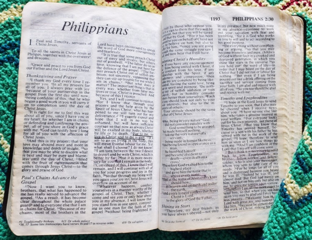 Battered old Bible open at Philippians